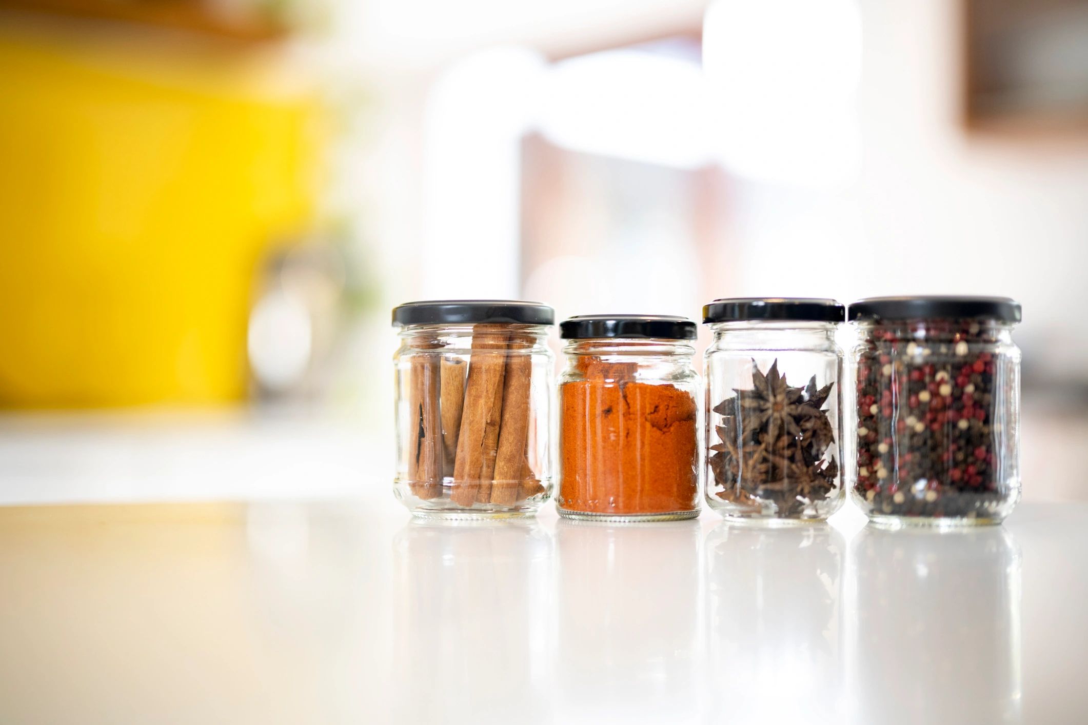 Glass jars with spices on a kitchen counter