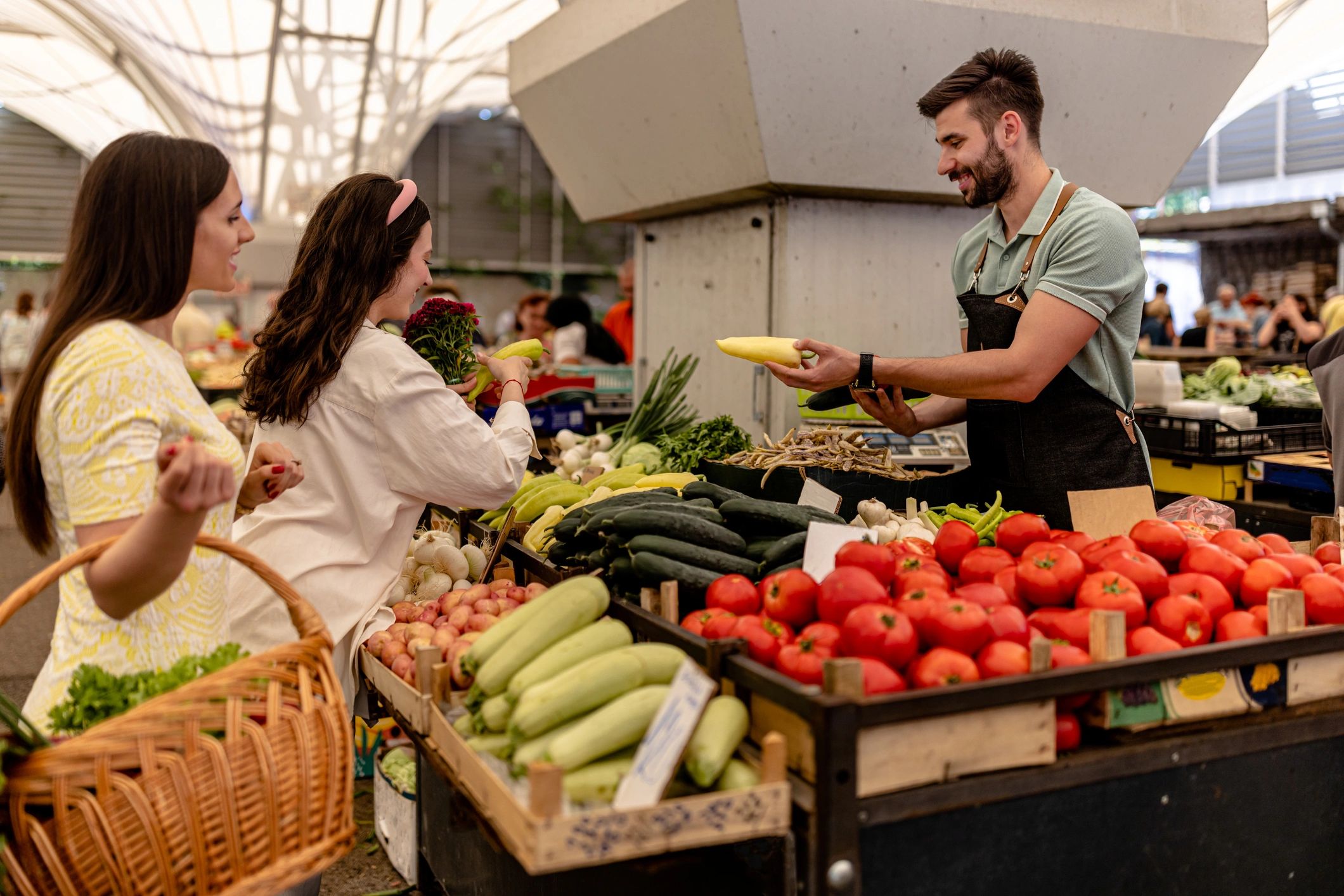 Shoppers selecting produce at an outdoor market