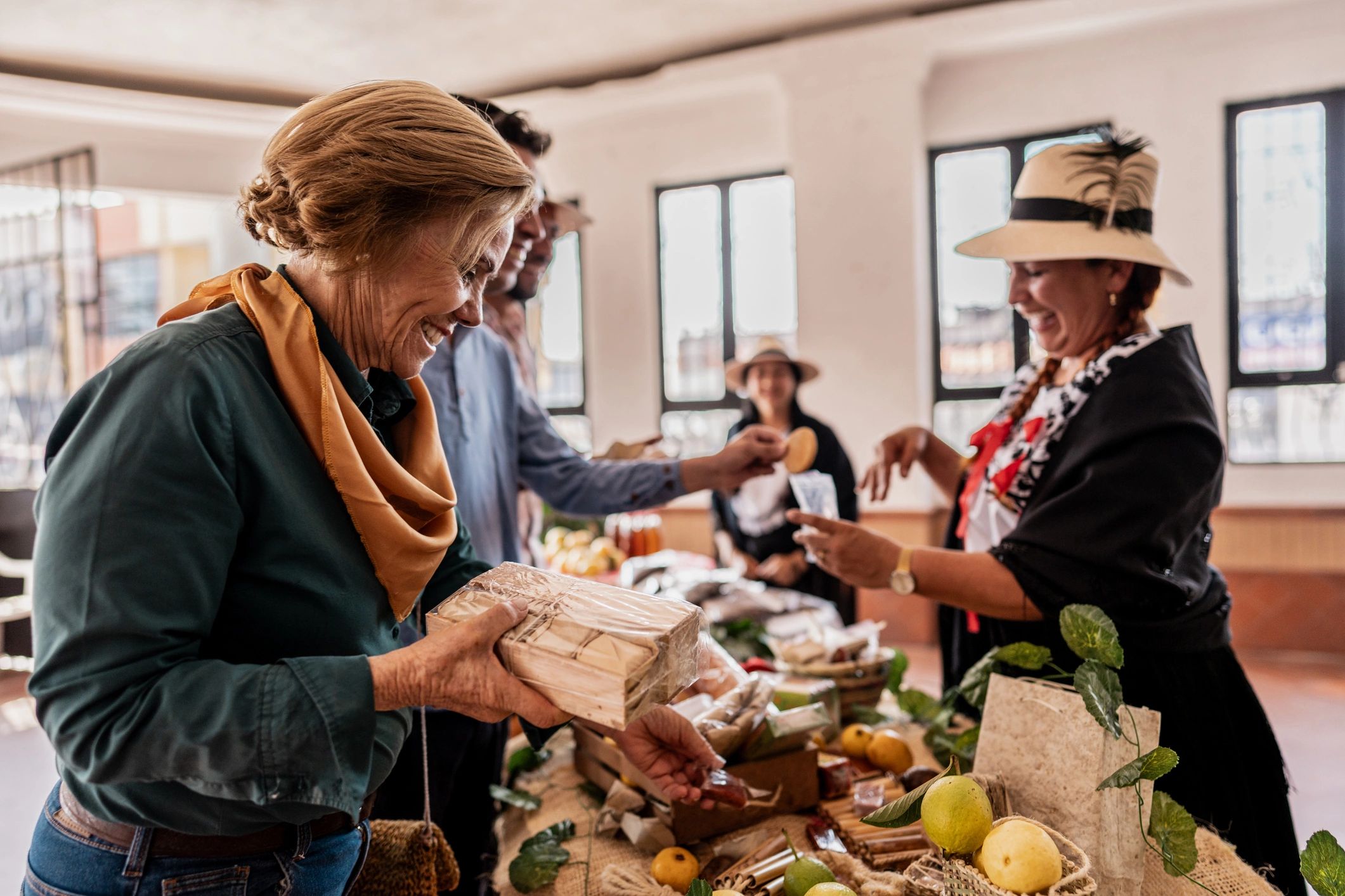 Customers speaking with a vendor at a local products stall