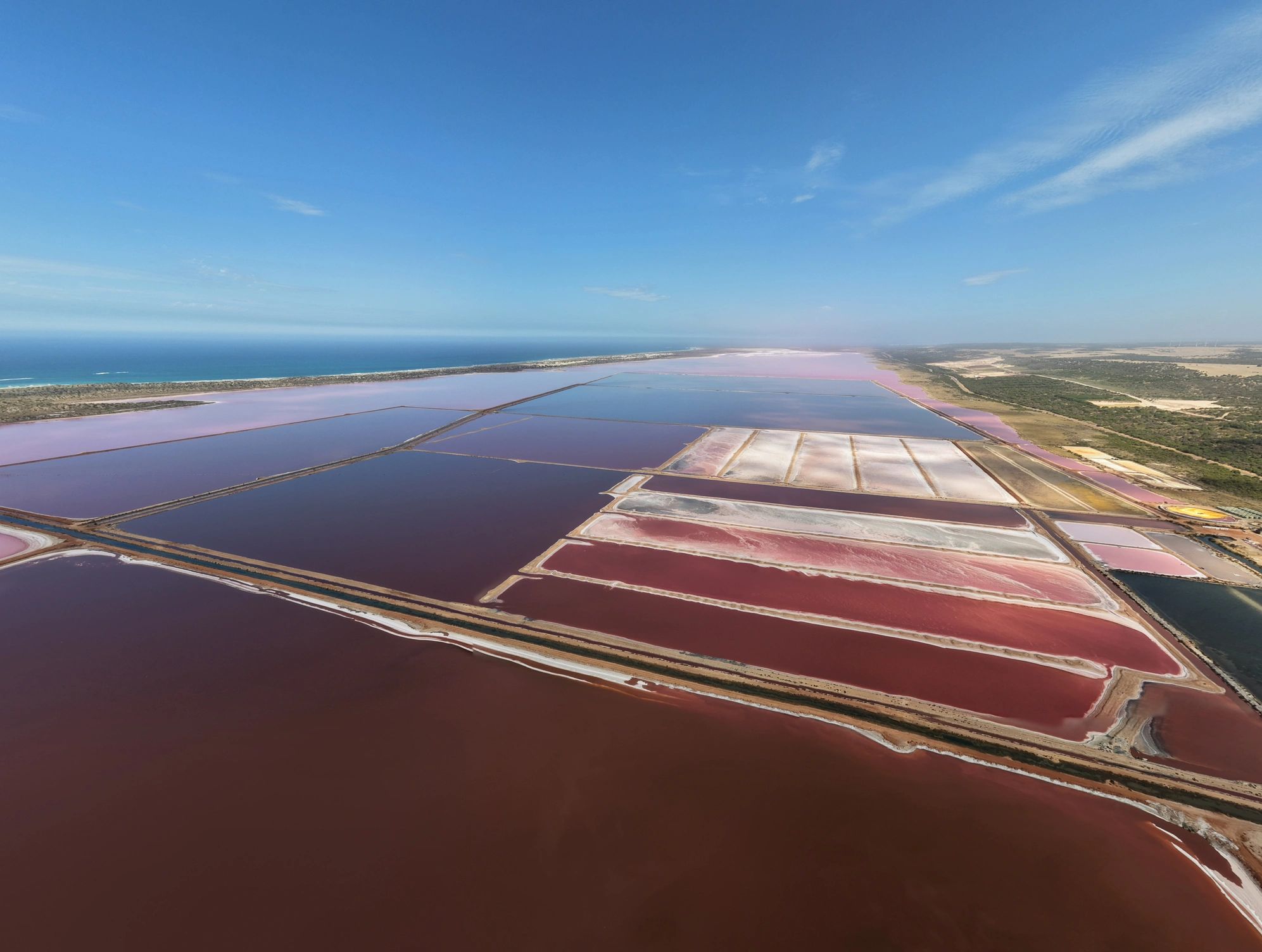 Aerial view of salt flats with vivid natural color and coastline